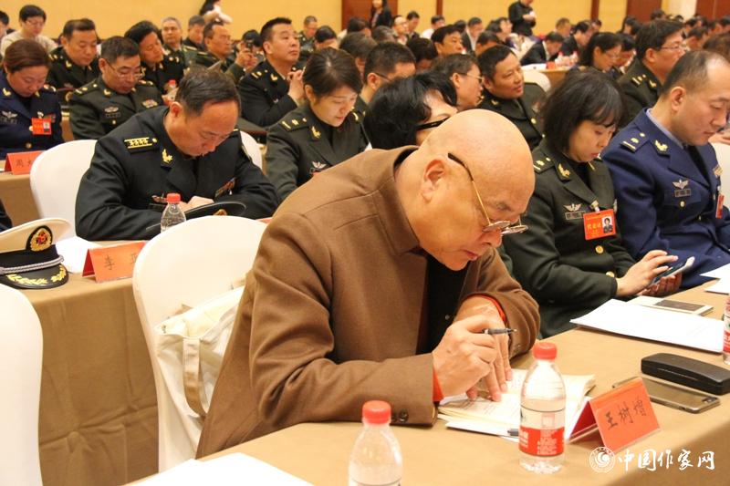 在中國作家協會第九次全國代表大會第三次全體會議上，代表王樹增認真作筆記。